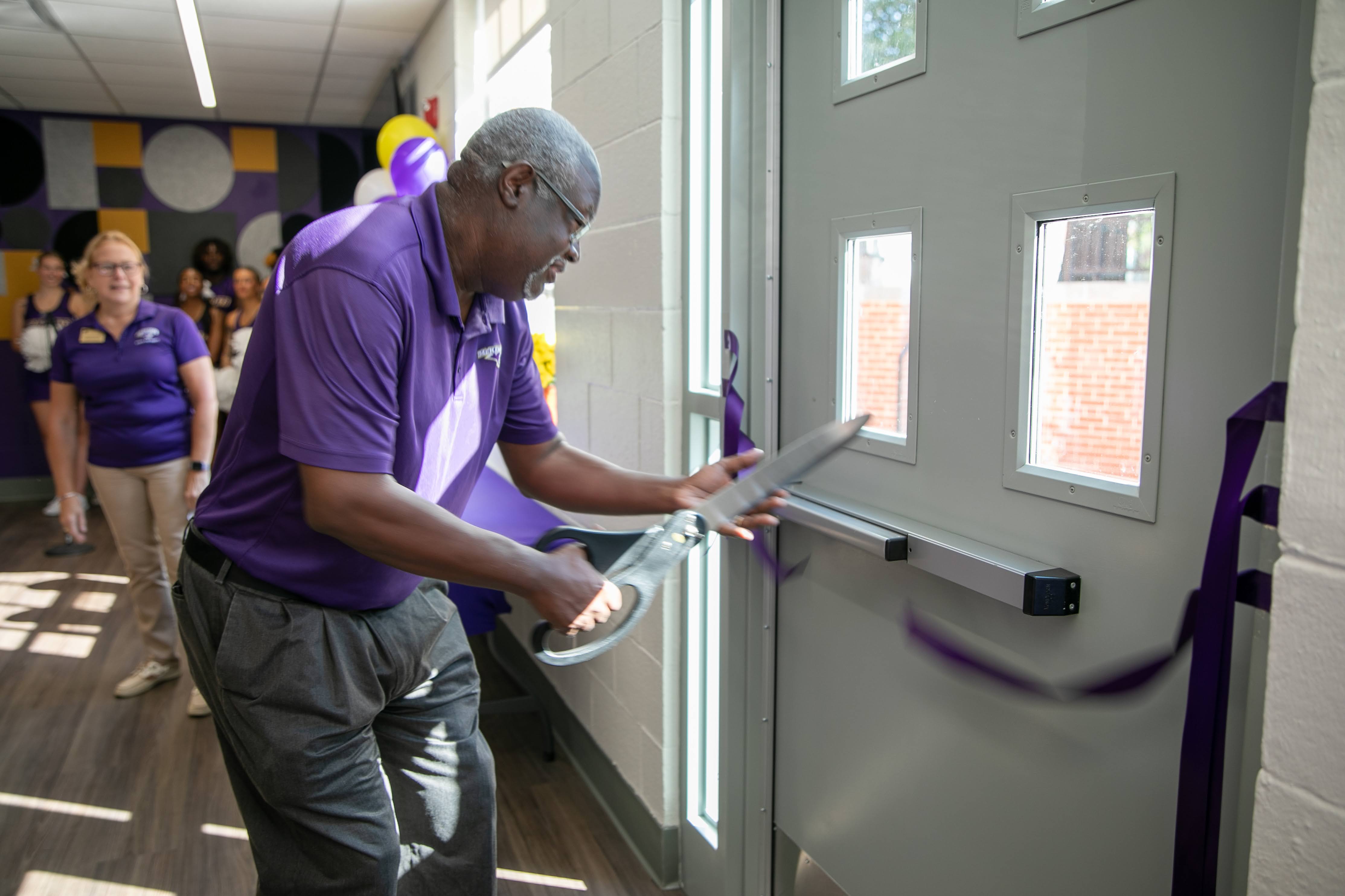 Craig Robertson participates in ribbon cutting for The Lair