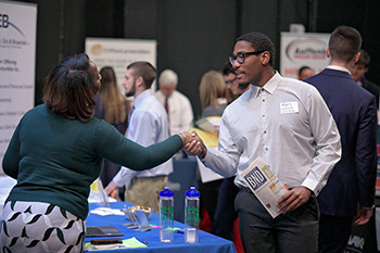 Male Student Shaking Hands at Career Fair