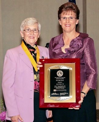 Photo of Janet Eckert Receiving Award from Victoria Dowling